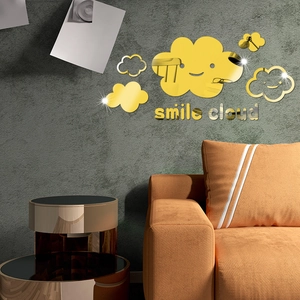 Golden acrylic mirror wall stickers with smile cloud design on a living room wall