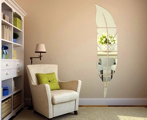 Detail of silver acrylic feather mirror wall sticker on a light yellow living room wall