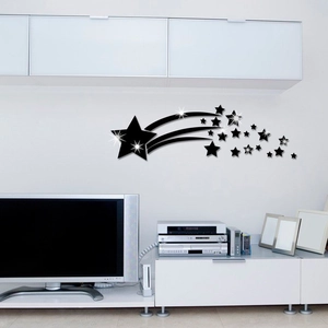 Detail of black acrylic comet and star wall stickers in a modern living room setting