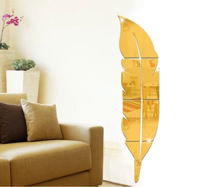 Detail of golden feather acrylic mirror wall sticker with reflective surface on wall