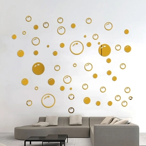 Modern gold acrylic mirror circle wall stickers displayed on a living room wall