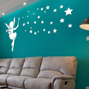 Close-up of reflective silver mirror fairy and stars wall stickers on a dark wall