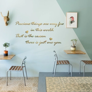 Detail of gold mirror acrylic wall sticker with precious quote and heart accents