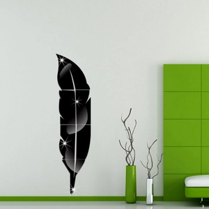 Detail view of 3D black acrylic feather mirror wall stickers on a minimalist white living wall