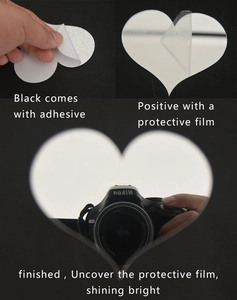 Detail showing adhesive backing and protective film removal on acrylic heart mirror sticker