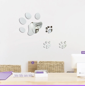 Close-up of four dog paw acrylic mirror wall stickers with reflective silver surface