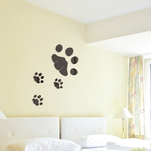 Detail of dark brown animal paw print wall stickers on a bedroom wall surface