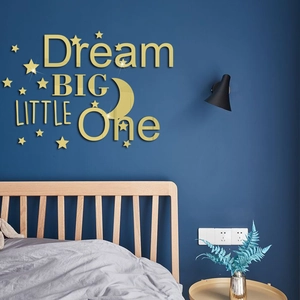 Detail of golden acrylic mirror wall stickers with Dream Big Little One text and stars