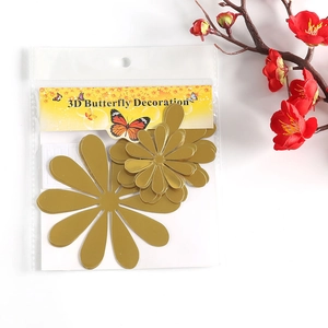 Detail view of 3D gold mirror flower wall stickers in packaging with adhesive pads