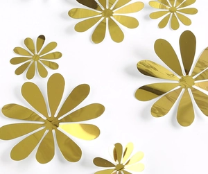 Detailed macro view of golden mirror flower wall stickers in various sizes with sharp reflections