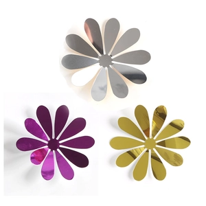 Close-up of mirror-finish daisy wall stickers in silver, purple, and gold colors