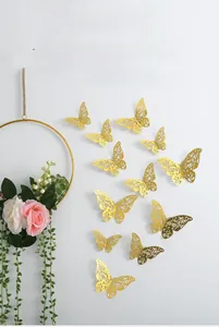 Detailed laser-cut gold butterfly wall stickers with intricate 3D hollow patterns on wall