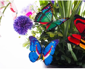 Detail of 12cm double-layered PVC garden butterflies on stems for outdoor floral decor