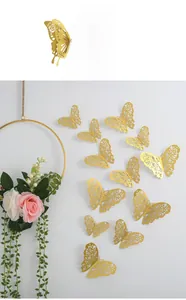 Detailed close-up of 3D hollow gold butterfly wall stickers with intricate floral patterns