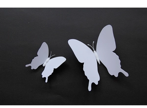 Detailed macro view of 3D white PVC decorative butterflies showing wings and texture