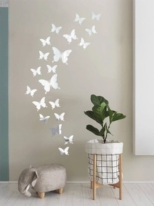 Detailed view of silver mirror butterfly wall stickers arranged in a 3D flying pattern