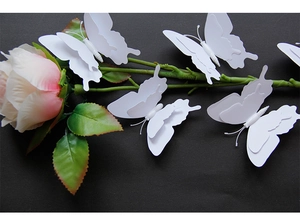 3D double-layered white butterfly wall stickers arranged on black textured background