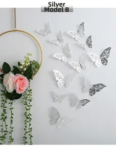 Detailed silver 3D hollow butterfly wall stickers with floral carvings on white wall
