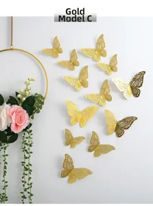 Detailed view of 3D hollow golden butterfly stickers with metallic texture on white wall