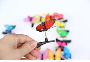 Detail of colorful butterfly hair clips with flexible springs on a white background