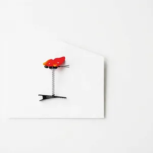 Realistic red butterfly hair clip with spring mechanism and black metal duckbill base