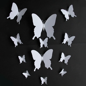 Set of 12 white 3D PVC butterfly wall stickers in various sizes on black background