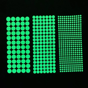Detailed view of luminous wall stickers in three sizes on black background