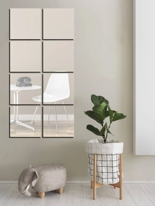 Modern wall decoration with 8-piece square acrylic mirror tiles in a home setting