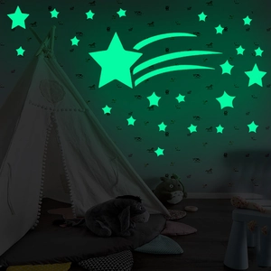 Luminous comet and star wall stickers glowing in a dark children's bedroom setting
