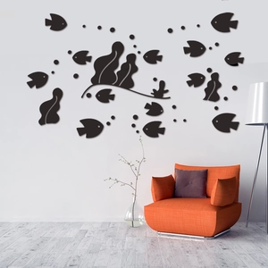 Black 3D acrylic ocean fish wall stickers set displayed above a cozy living room sofa