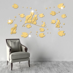 Detailed view of 3D gold acrylic mirror fish wall stickers in a modern living room setup