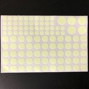 Detailed sheet of luminous dot stickers in various sizes for glowing wall decoration