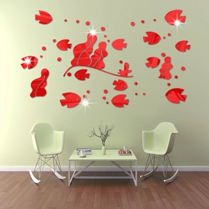 Detail view of red 3D acrylic mirror fish wall stickers on a green living room wall