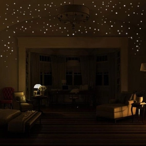 Luminous wall stickers showing a glowing starry sky effect in a dark bedroom setting