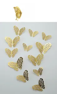 Macro detail of 3D golden hollow butterfly wall stickers with intricate laser-cut patterns