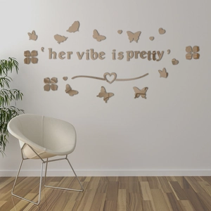 Detailed close-up of gold mirror acrylic butterfly wall decals and letter wall art decor