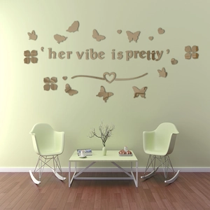 Close-up of champagne gold acrylic butterfly wall decals with 'her vibe is pretty' text