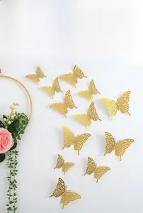 Close-up of golden 3D hollow butterfly wall stickers with intricate laser-cut wings