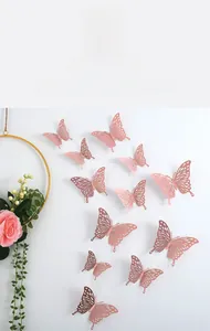 Macro detail of 12 rose gold 3D hollow butterfly wall stickers for home decor