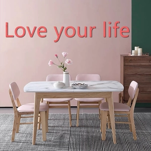 Modern marble-top dining table with four pink upholstered chairs in home setting