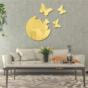 Modern gold butterfly acrylic mirror wall stickers displayed on a textured grey living room wall