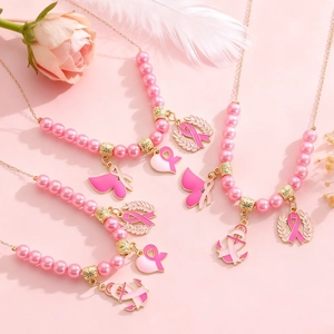 Détail de colliers de perles roses avec pendentifs ruban rose contre le cancer