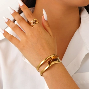 Detail of 18k gold plated stainless steel open bangle and ring set with tiger eye stones