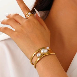 Detail of 18k gold plated stainless steel cuff bracelet and ring set with pearl inlays