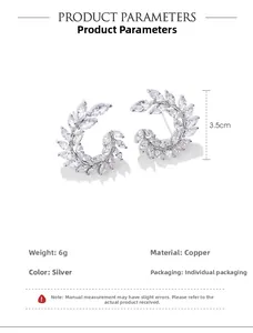 Detail of silver leaf cluster C-shape earrings with zircon marquise stones and measurements