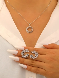 Bridal zircon necklace and earrings set with olive leaf design on a female model
