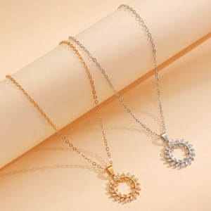 Luxurious gold and silver olive leaf round necklaces with zirconia on an elegant display