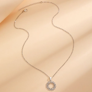 Elegant silver zirconia floral leaf necklace featuring a radiant sunburst wreath pendant