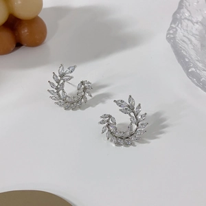 Macro shot of silver olive leaf stud earrings set with marquise-cut cubic zirconia crystals