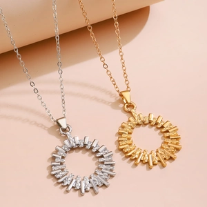 Macro shot of circular openwork pendants with geometric radial stripes in gold and silver